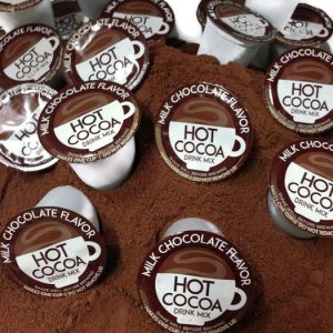 hot chocolate single service pods sitting in pile of cocoa